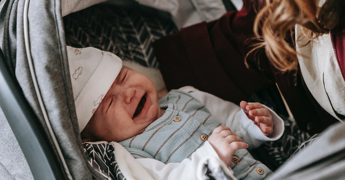 a crying baby in their carseat