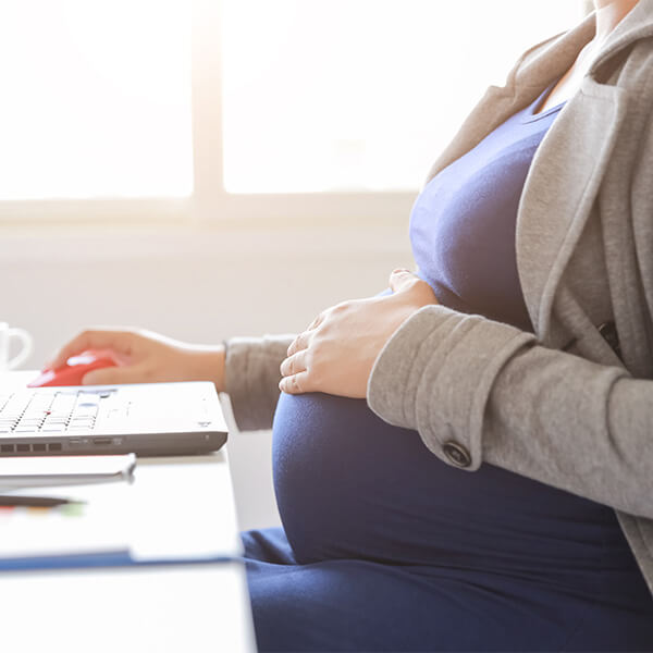 pregnant woman at laptop
